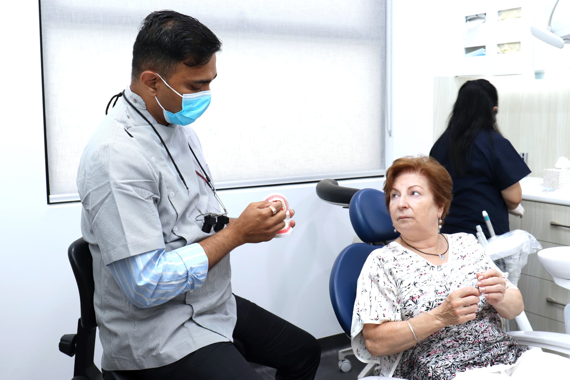 Friendly clinician with an elderly patient at Endeavour Smiles Group