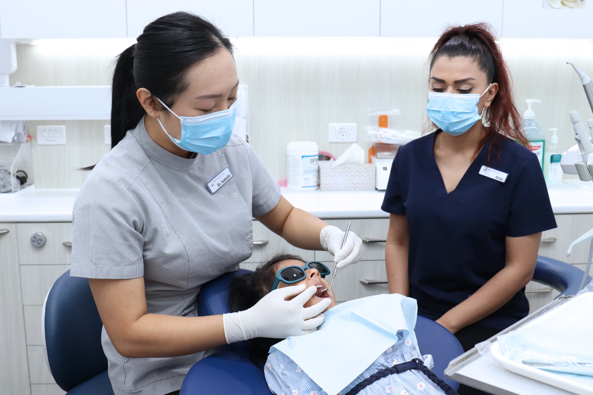 Dr Isabelle Seow and dental assistant Shai-lee treating a young patient at Endeavour Smiles Group