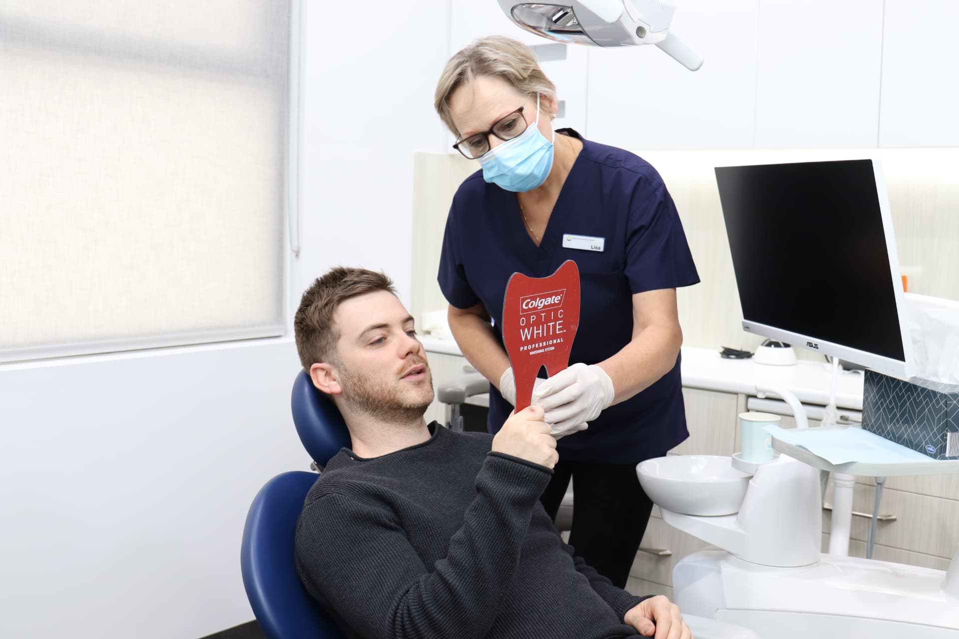 Clinician showing a patient professional teeth whitening options